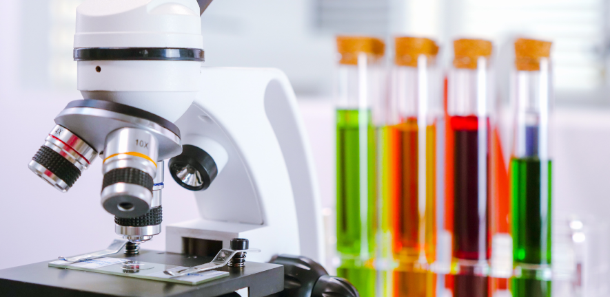 microscope and test tubes in the background