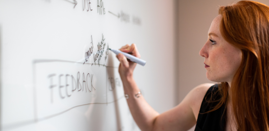 woman writing on whiteboard